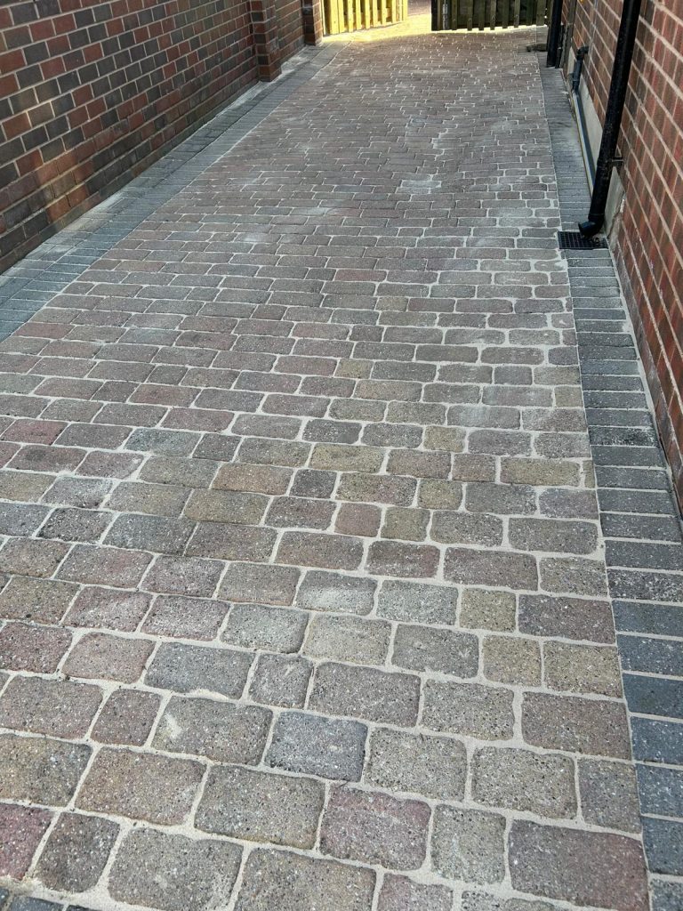 An after picture of a driveway that has been cleaned.