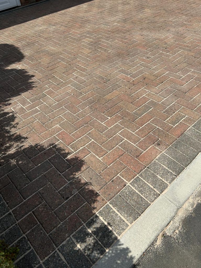 A driveway that has been cleaned by a pressure washer.