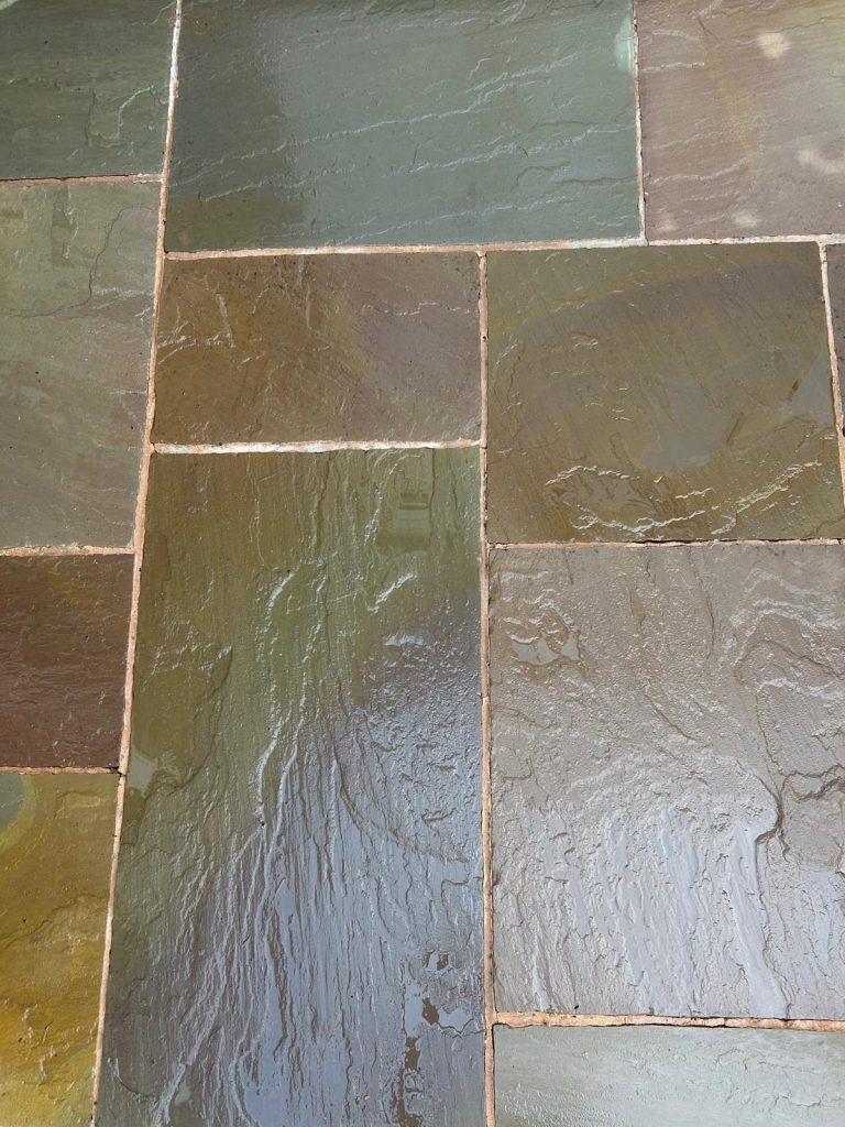 A picture of some patio slabs after being cleaned