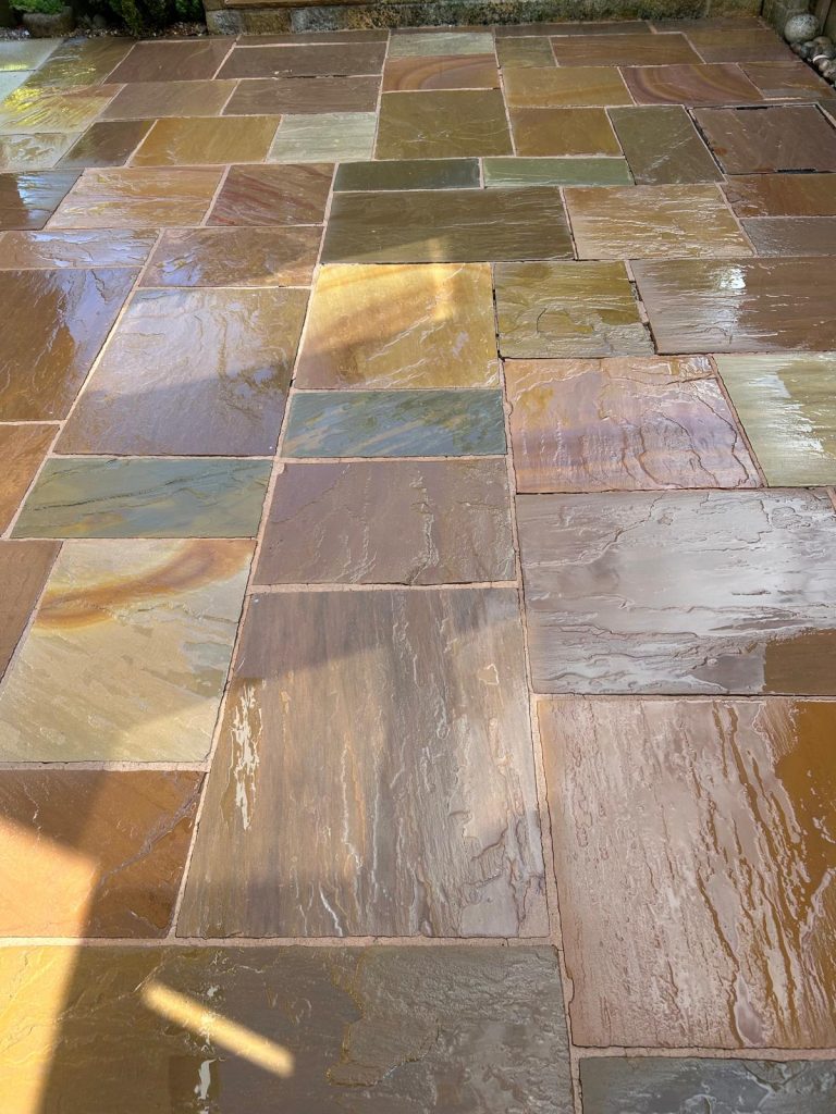 A after image of a driveway cleaned by pressure washer