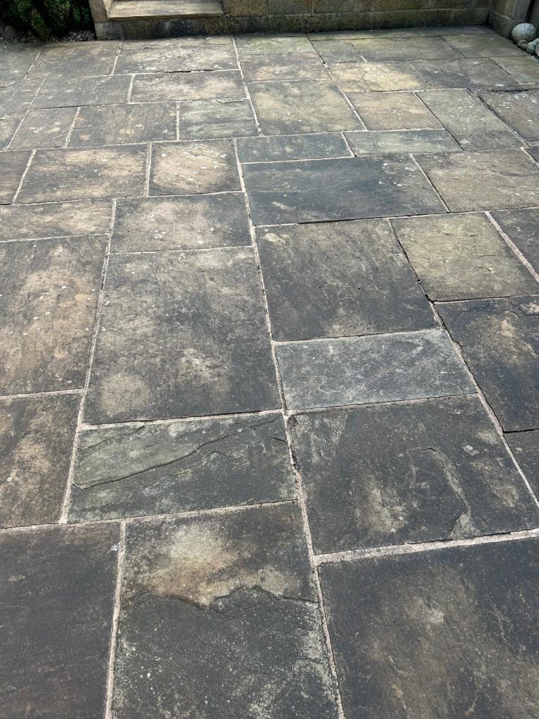 A before image of a driveway cleaned by pressure washer